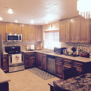 A cozy kitchen with wooden cabinets and modern appliances.