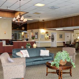 A spacious and inviting lobby area featuring comfortable seating and decorative elements.