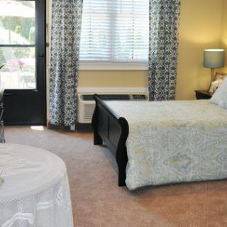 A cozy bedroom with a bed, window, and decorative elements.