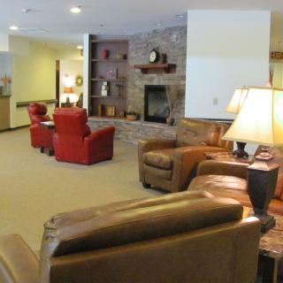 A cozy living room featuring comfortable armchairs and a fireplace.