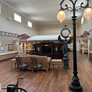A spacious and inviting lobby featuring comfortable seating, a decorative clock, and warm lighting.