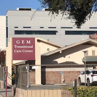 A view of the GEM Transitional Care Center, showcasing its distinct signage and architectural design.