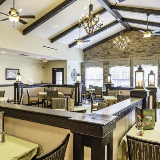 A modern restaurant interior with tables and chairs arranged in a spacious dining area.