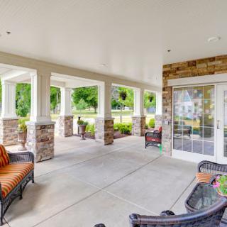 A spacious and inviting porch area featuring outdoor seating, perfect for relaxing and enjoying the view.