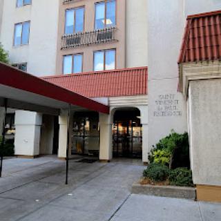 The entrance of a modern residential building featuring a covered walkway.