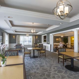 A spacious and elegantly designed dining area with modern furniture and lighting.