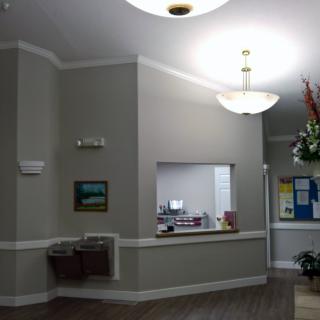 A well-lit reception area with an office desk and decor.