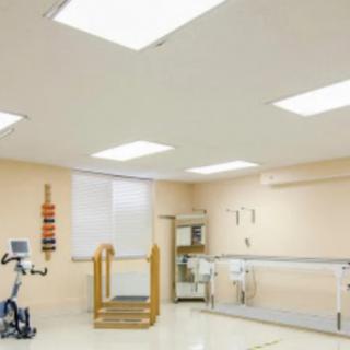 A rehabilitation gym with exercise equipment and a spacious layout.