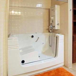A modern bathroom featuring a spacious bathtub and a water heater on tiled walls.