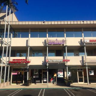 A view of a multi-storey shopping center with various businesses.