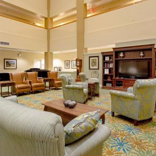 A spacious living room with comfortable seating and a large television.