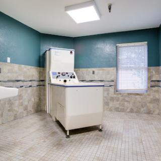 A spacious laundry room featuring a vintage washing machine and modern decor.