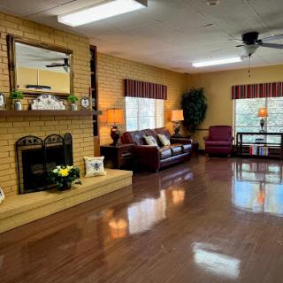 A cozy and inviting living room with a fireplace, comfortable seating, and warm lighting.