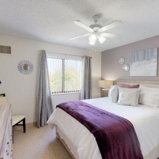 A cozy bedroom with a large bed, soft lighting, and elegant decor.