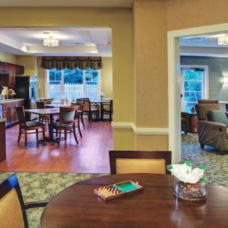 A cozy interior featuring a dining area, open kitchen, and a living room with comfortable seating.