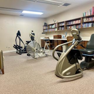 A well-equipped indoor fitness space featuring various exercise machines.