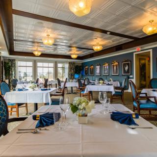 An elegant restaurant interior with neatly arranged tables and chairs.