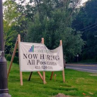 A sign indicating that a company is now hiring for all positions.