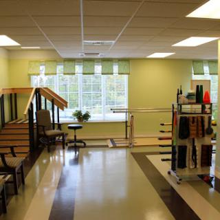 A spacious and well-lit physical therapy area equipped for rehabilitation exercises.