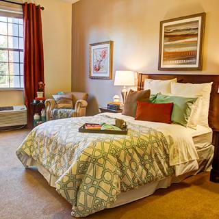 A cozy bedroom with warm lighting and elegant decor.