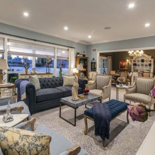 A stylishly designed living room with comfortable seating, elegant decor, and warm lighting.