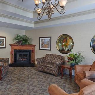 A cozy living room with a fireplace, comfortable seating, and elegant decor.