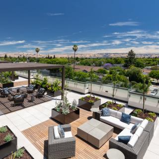 A modern outdoor patio with comfortable seating and a scenic landscape view.