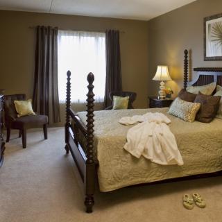 A cozy bedroom with elegant decor and a comfortable bed.