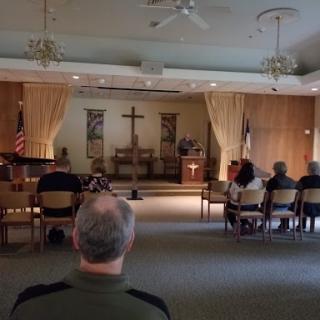 A serene moment during a church service, with attendees seated in reflection.
