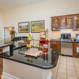Bright modern kitchen with a black countertop and wooden cabinets.