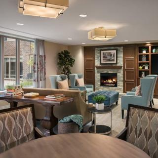 A modern and cozy living room with elegant furnishings and a warm fireplace.