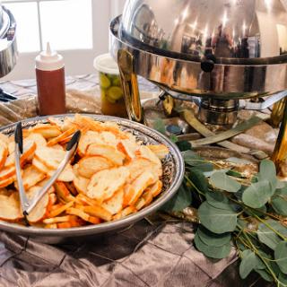 A savory spread featuring crispy potato wedges on a buffet table.