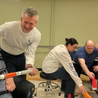 A group of people engaging in a team-building activity indoors.