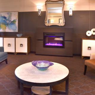 A cozy and modern living room featuring a stylish fireplace and elegant furniture.