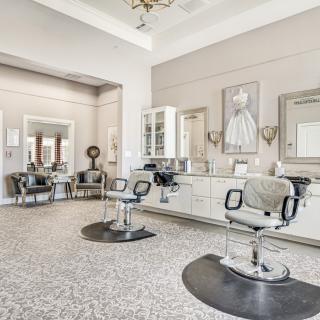 A modern and stylish salon interior with empty chairs and mirrors.