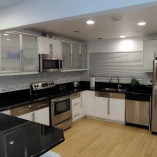 A modern kitchen with stainless steel appliances and sleek cabinetry.