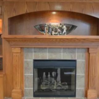 A stylish wooden fireplace with a decorative mantel.