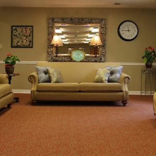 A cozy living room featuring comfortable couches, decorative elements, and soft lighting.