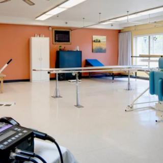 A spacious physical therapy room equipped with rehabilitation devices.