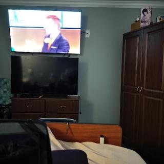 A cozy living room featuring a mounted television and a stylish wall unit.