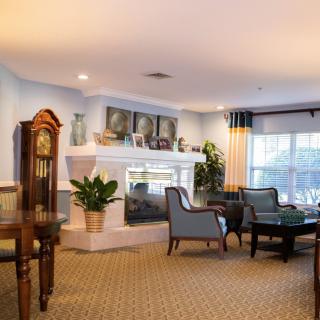 A cozy living room with a fireplace, comfortable seating, and tasteful decor.