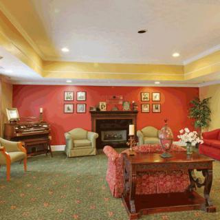 A cozy living room with a fireplace and traditional decor.
