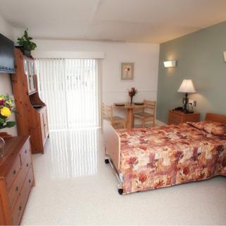 A cozy hotel room with floral bedding and warm furnishings.