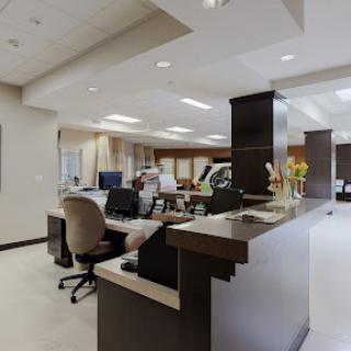 A modern office reception area with workspace and comfortable seating.