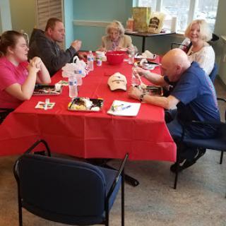 A group of people enjoying a meal together at a dining table.