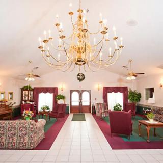 A luxurious lounge area featuring a grand chandelier and classic furnishings.