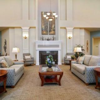 Elegant living room with classic furniture and a cozy fireplace.