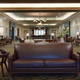 A classic hotel lobby with elegant furnishings and warm lighting.