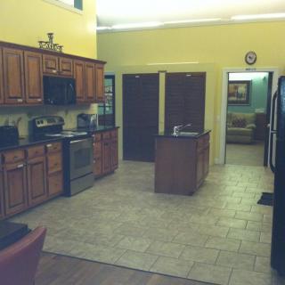 A spacious kitchen with wooden cabinets and a central island.