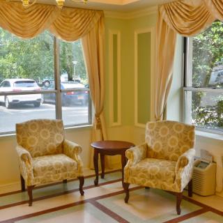 Cozy seating area with patterned chairs and natural light.